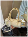 Cream yellow cylindrical handbag with a decorative pearl bow and a lace ribbon detail. - Yellow (With Pearl Lace Pendant) / Yellow