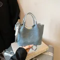 Chic light blue denim bucket bag with silver handles and adjustable crossbody strap - Silver