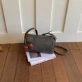 Grey textured pillow crossbody bag for women featuring a cute red strawberry charm - With Pendant / Black
