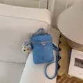 Minimalist blue textured mini bucket crossbody bag with plush bear charm - Blue with Pendant