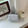 Elegant silver Boston pillow bag featuring top handle and versatile crossbody strap - Basic Style / Silver