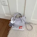 Lavender textured leather bucket bag with top handle and plush bunny charm - Purple with Pendant