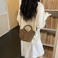 Brown woven texture bucket bag featuring a round handle and matching small pouch accessory - Coffee