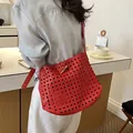Retro woven leather shoulder bucket bag for women, stylish hollow crossbody handbag. - Red