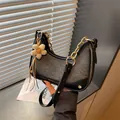 Chic grey denim crescent crossbody bag with elegant gold chain strap and flower charm - With Pendant / Black