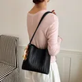 Elegant black woven shoulder bag featuring a stylish wooden bead tassel charm detail - Black With Rabbit Pendant