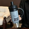 Close-up detail of stainless steel tumbler with large handle and modern striped design. - Gray