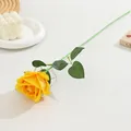 Close-up detail of a single yellow artificial flannel rose with green stem and leaves. - Small Velvet Yellow