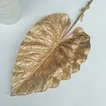 Gold hollow leaf decorative detail shot, elegant wedding floral arrangement prop for display. - Single Fittonia Leaf
