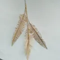 Golden artificial plant leaf detail shot, exquisite wedding decoration branch for nice display. - Three-Pronged Feathers
