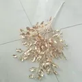 Detailed shot of gold artificial plant leaf branch, ideal for wedding display and decor. - Pear Tree Leaves