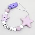 Close-up detail of silicone pacifier clip with cute koala charm and BABY letter beads - Purple