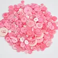 Bulk mix of pink resin buttons in various sizes for DIY crafts and sewing projects. - Pinkish