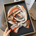 Silk scarf variant featuring geometric print and elegant orange border for women daily styling. - 19213-Main Image