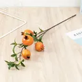 Artificial pomegranate branch detail showing realistic orange fruit and green leaves. - 4-Head Pomegranate / Yellow