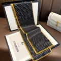 Elegant black silk twilly scarf with golden trim and geometric pattern for women fashion. - Black