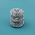Stack of three stainless steel wire cleaning balls for heavy-duty kitchen scrubbing. - Single Steel Wire Ball