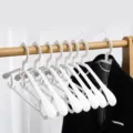 White plastic clothes hangers with wide shoulder non-slip design for home wardrobe organization - Wide Shoulder Non-Slip Style / Coconut Milk White