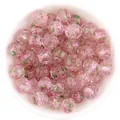 Closeup of pink faceted glass beads with rose pattern and sparkling gold sand for DIY crafts. - Light Pink