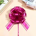 Nahaufnahme einer metallischen fuchsiafarbenen Ziehschleife für Geschenkverpackungen - Fuchsia