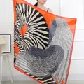 Elegant large square scarf with striking zebra and wing print on vibrant orange background. - Orange Pegasus