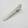 Silver metal tie clip for men, textured geometric pattern, elegant business accessory detail. - Raised Dots