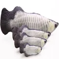 Close up detail of four soft plush fish cat toys in varying sizes with realistic scale print. - Silver Arowana