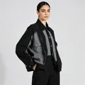 Detail shot of unisex oversized color block denim jacket with black and grey tones - One Size / Black