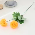 Detail view of artificial pompon chrysanthemum flower branch with vibrant yellow heads and green leaves. - Two-Headed Ping Pong Chrysanthemum - Orange