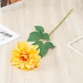 Artificial yellow dahlia flower detail, featuring realistic petals, green leaves and stem. - Yellow