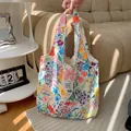 Detailed view of the colorful floral canvas vest bag, showing vibrant print and fabric texture. - Spring Garden Floral
