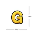Close-up detail of a gold embroidered letter G patch for apparel decoration and DIY repair. - Letter G