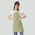 Waterproof green and white striped kitchen apron with large front pocket worn by model - Breathable cotton and linen stripes - light green [1 piece]