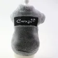 Detailed close-up of grey plush dog vest showing soft texture and black brand patch - XS / Gray