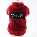 Detailed view of a red fluffy dog fleece vest with a brand logo patch on the back - XS / Red