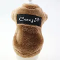 Close-up of brown plush pet coat featuring a black Coxji brand patch on the back - XS / Coffee