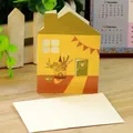 Creative house-shaped hollow greeting card with a white envelope on a wooden desk - Bird Hut