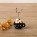 Cute resin cat in a coffee cup card holder with a gold star-shaped metal wire clip. - Black Cat Teacup
