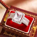 Detailed view of an elegant emerald-cut zircon engagement ring in a vintage red box - Size 6 / Square Zirconia Style (KYRA0868)