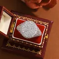 Detail view of a sparkling full pavé iced-out ring in a vintage red velvet box - Size 6 / Pave Oversized Style (KYRA02095) / White Gold