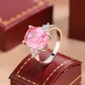 Macro view of a silver engagement ring with a cushion-cut pink cubic zirconia - Size 6 / Silver with Pink Crystal