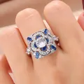 Elegant vintage square floral ring featuring blue and clear cubic zirconia on model's finger - Size 6 / Vintage Square Floral Style (KYRA0377)
