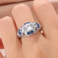 Close-up of vintage silver ring with blue stones and clear central crystal on hand - Size 6 / Silver Blue (KYRA0390)