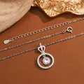 Close-up detail of an elegant silver necklace featuring a crown and circular zircon pendant - KYNL0482 (Crown Ring Style)