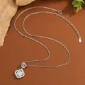 Detailed macro view of a silver four-leaf clover pendant necklace with cubic zirconia - Four Leaf Clover Crown / KYNL0391 (Clover Crown Style)