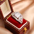 Close-up view of a luxury emerald-cut zircon ring inside a red velvet jewelry box on gold satin - Size 6 / Fancy Step Cut Square Diamond Style (KYRA0610) / Silver