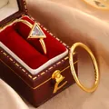Close-up of elegant gold-plated rings with triangular zircon in a luxury jewelry box - 6 / Gold (KYRA0514)