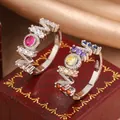 Detailed macro shot of silver MOM letter rings set with vibrant colorful gemstones on a red box - Size 6 / Colorful Zirconia