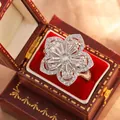Close-up macro view of silver camellia scarf buckle ring with sparkling white crystal petals - Size 6 / Camellia (KYRA0516) / Silver
