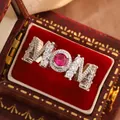 Close-up of MOM ring with red ruby stone and crystals in a vintage red box - Size 6 / Red Zircon